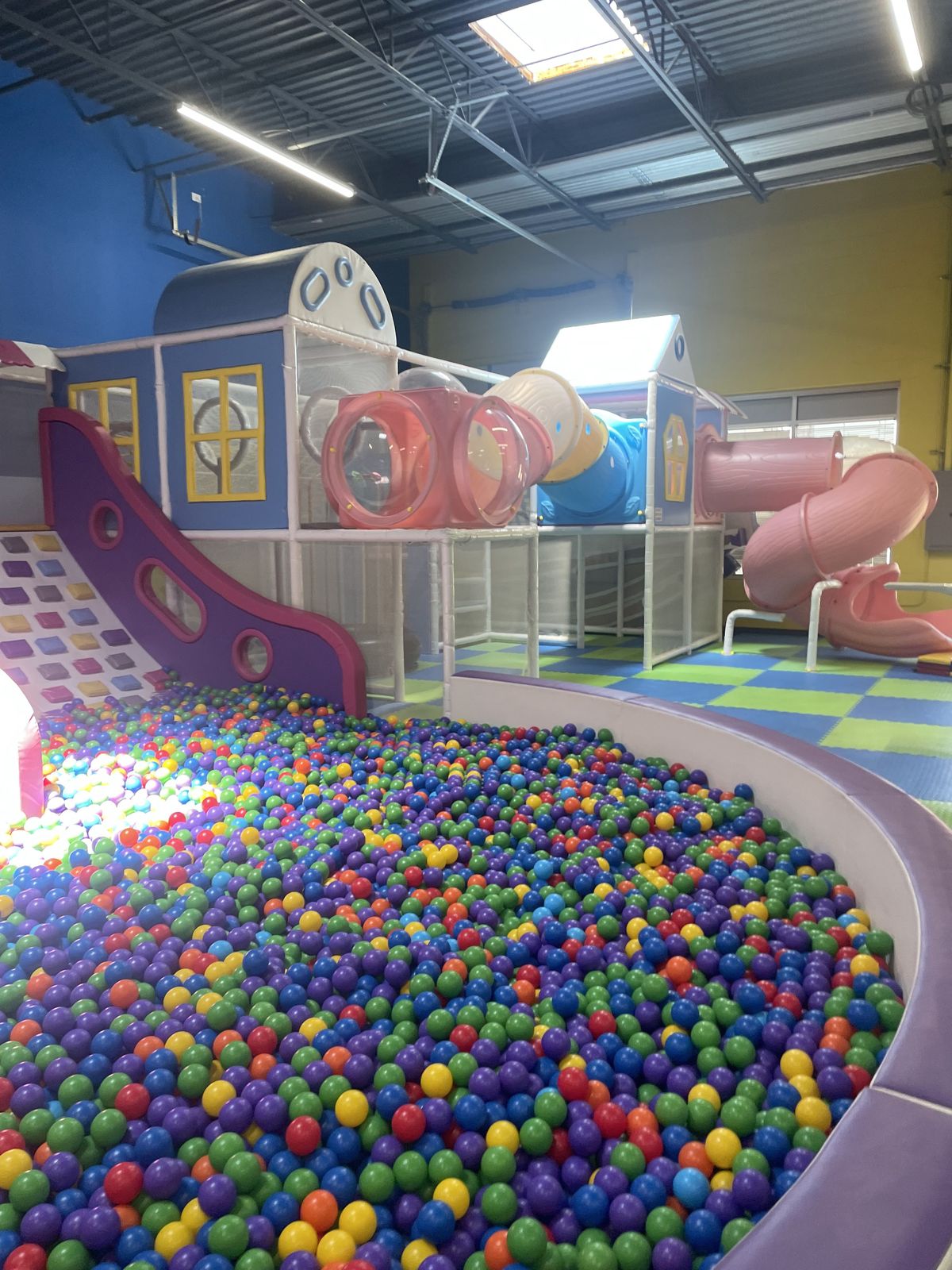 Airplane play structure beside the colorful ball pit