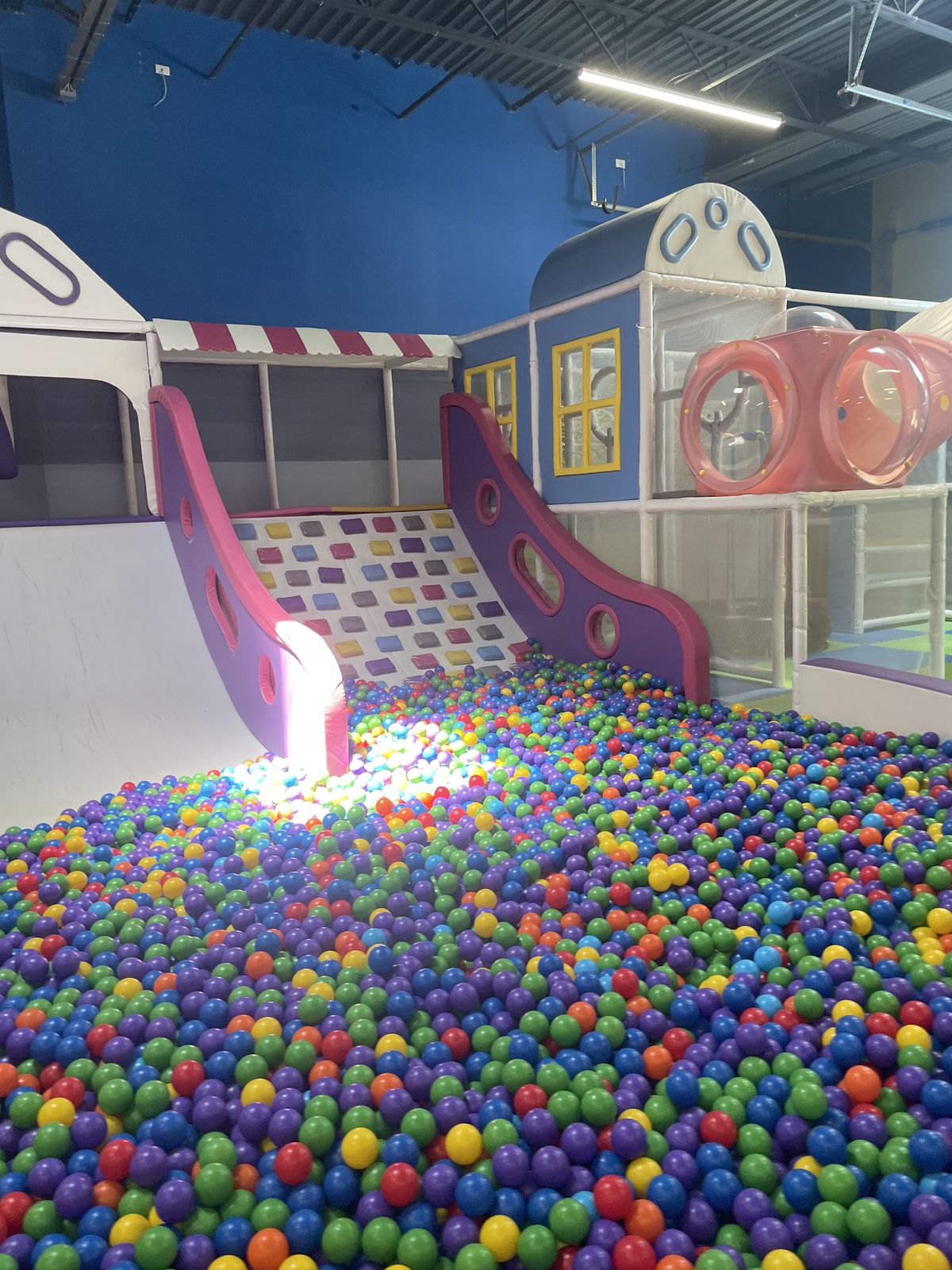Purple slide leading into the colorful ball pit