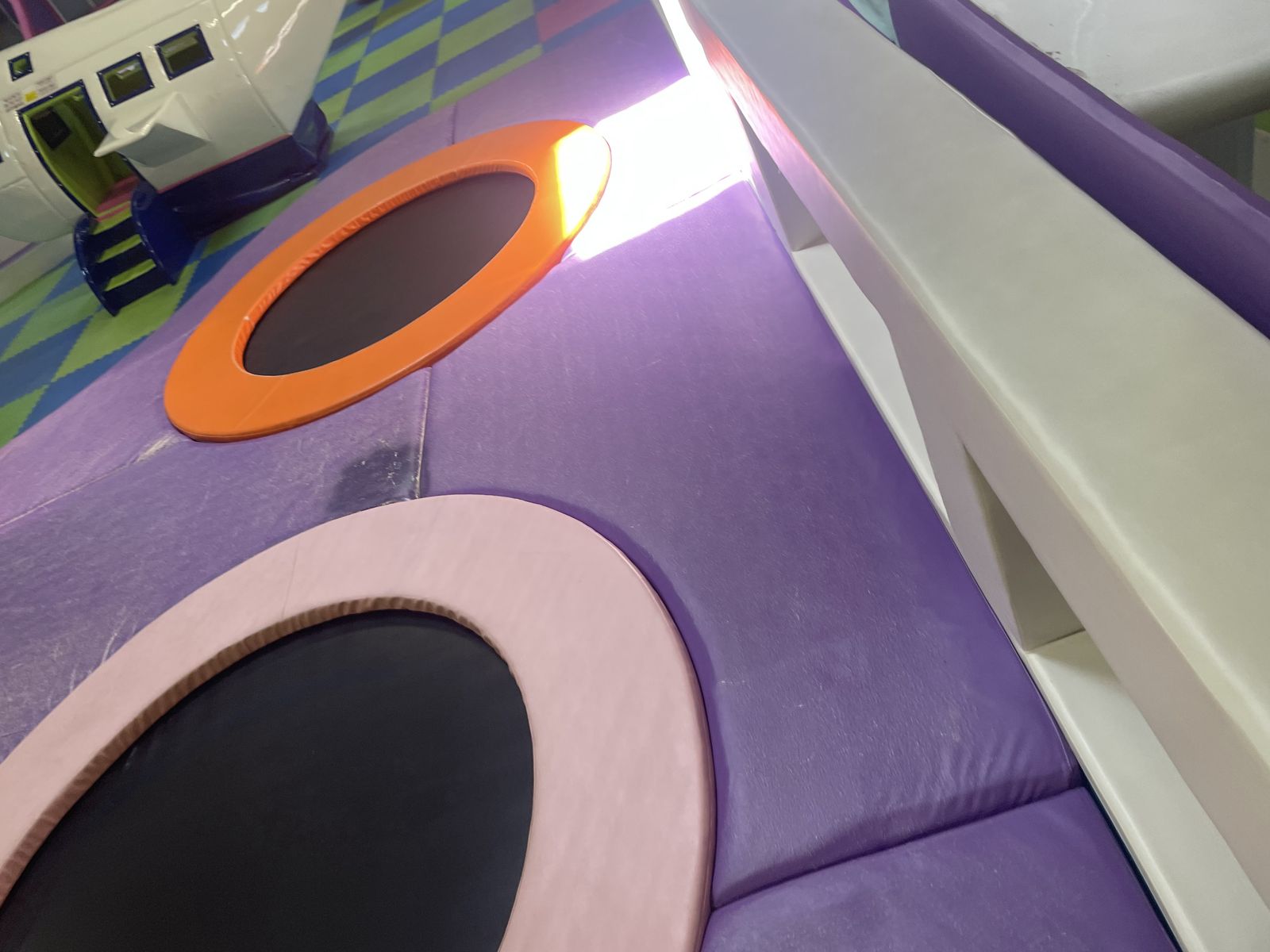 Close view of a trampoline beside the airplane structure