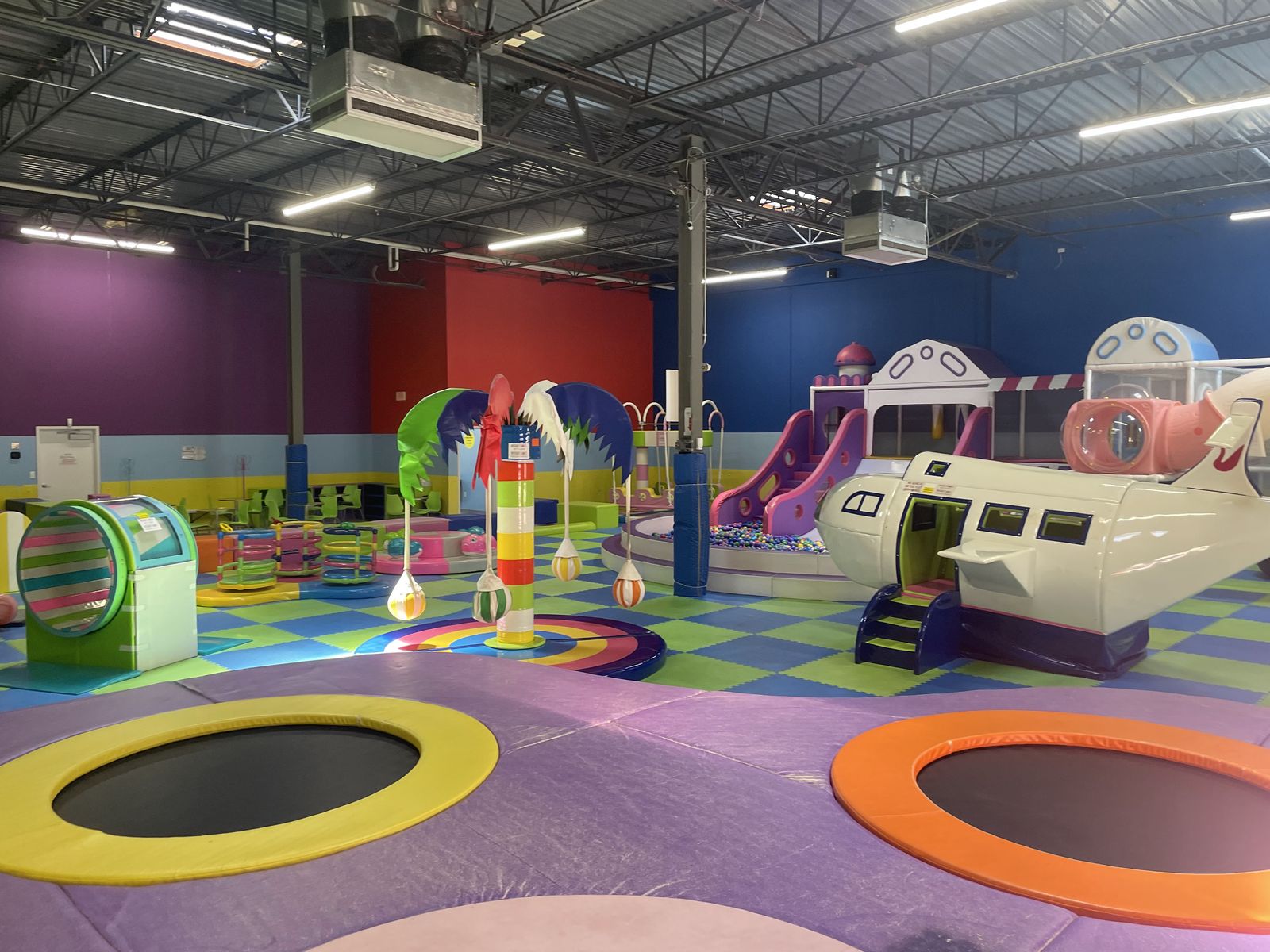Trampolines beside the airplane play structure