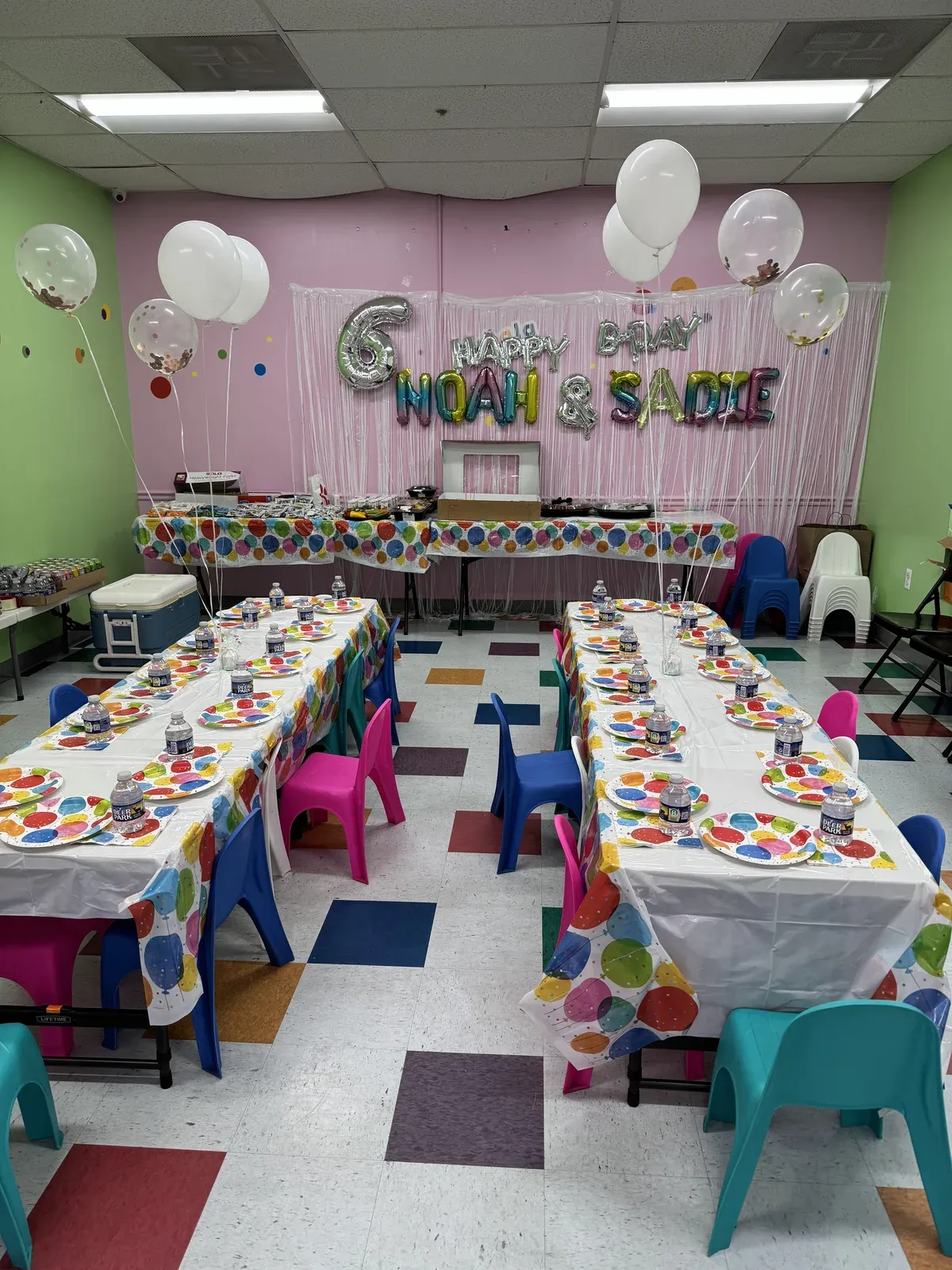 Pink balloon arch and long party tables
