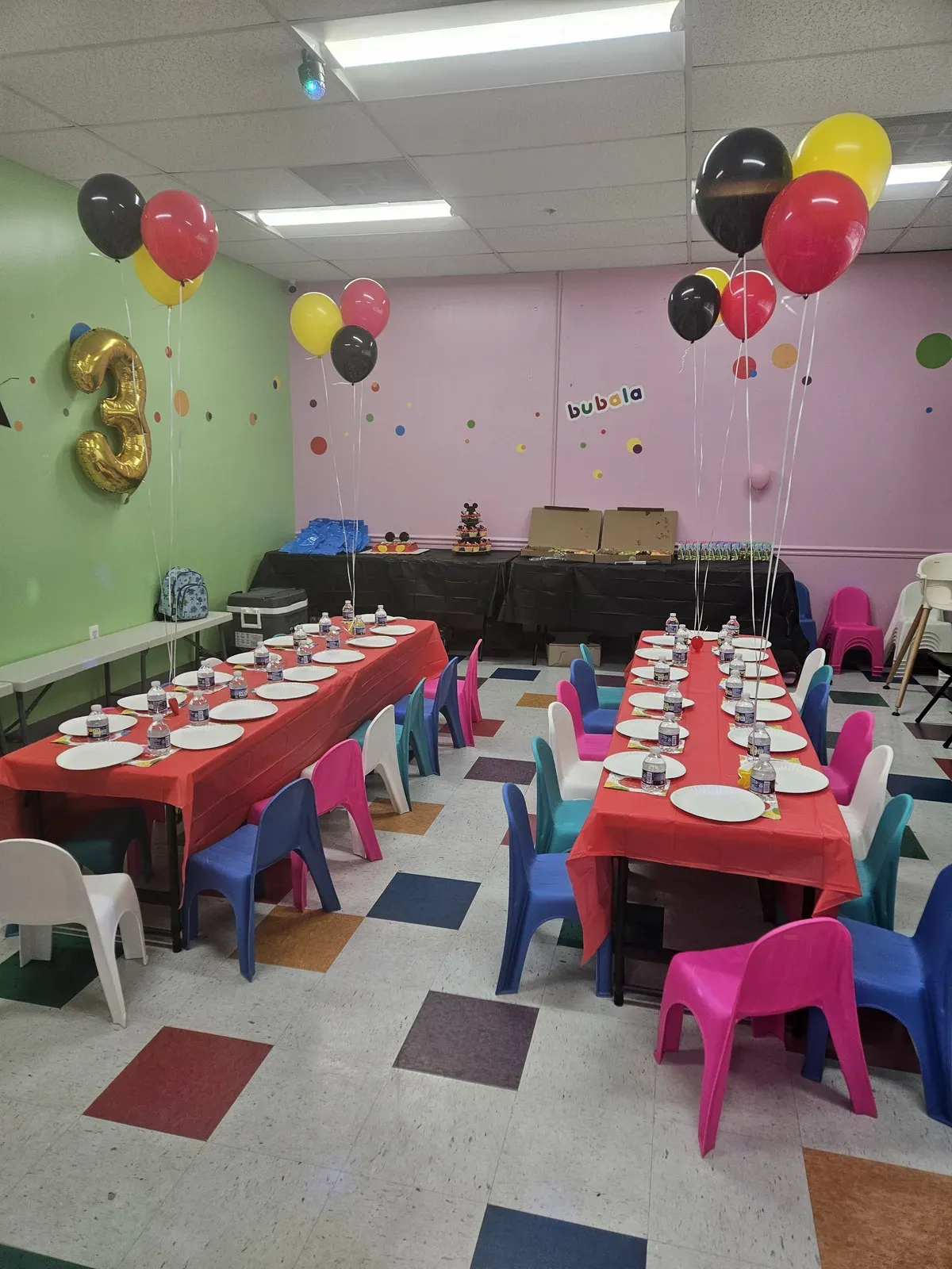 Red and gold party room with long table settings